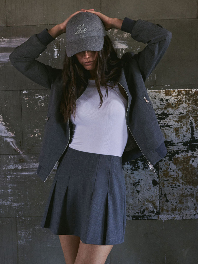Grey Women's Premium Golf Outfit Bomber Jacket Pleated Skirt Logo Cap - Front View On Model | Greyson Clothiers
