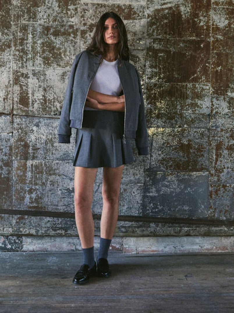 Grey Women's Luxury Golf Apparel Pleated Skirt & Bomber Jacket Full Length - Front On Model | Greyson Clothiers