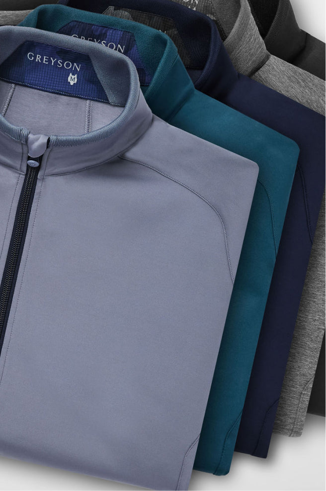 Stack of folded shirts in gray, teal, and navy with 'Greyson' branding.
